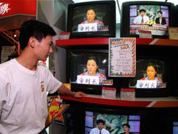 Open access to judicial proceedings is part of the free flow of information. Here, a man in China watches a televised trial.