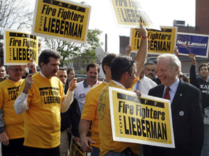 Connecticut senatorial candidate Joseph Lieberman courts firefighters in 2006. Interest groups are wooed and won by politicians one at a time.