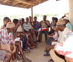 Democracy needs both conflict and consensus. In this photo, men in Sierra Leone discuss law.