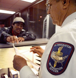An immigration officer in San Antonio, Texas, answers a question after a change in immigration laws in 1997.