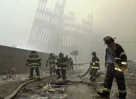 firefighters beneath the destroyed vertical struts of the World Trade Center's twin towers after the September 11, 2001, terrorist attacks in New York and Washington, D.C.
