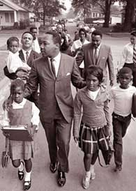 Martin Luther King Jr. escorts children to a previously all-white public school in Grenada, Mississippi, in 1966.