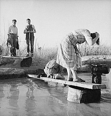 Oklahoma migratory workers washing in a desert hot spring