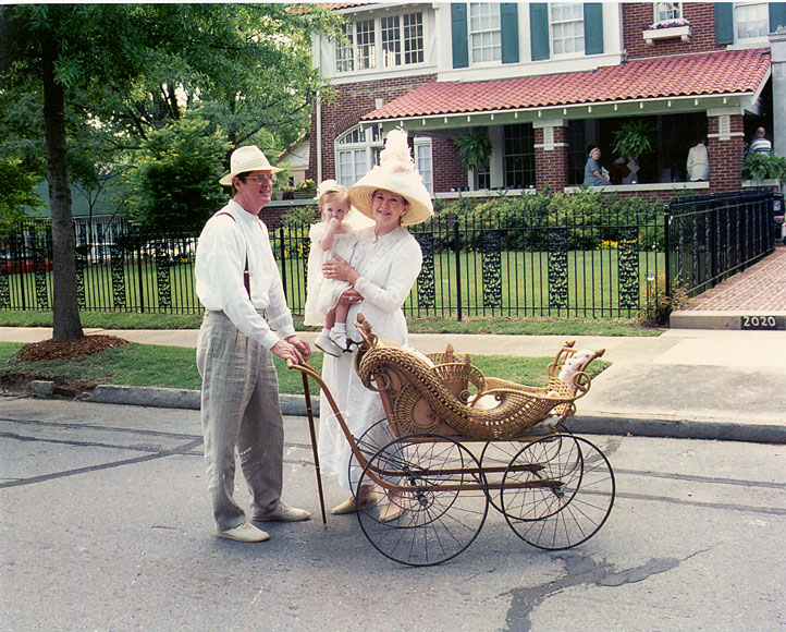 Photo of family in historic clothing in front of house