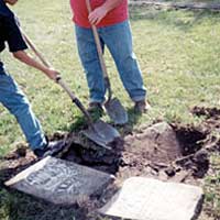 Photo of fifth-graders resetting a tombstone