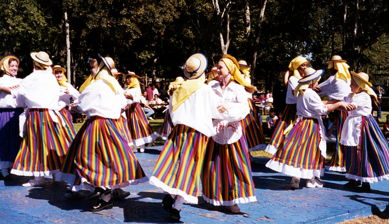 Photo of people dancing in brightly colored costumes
