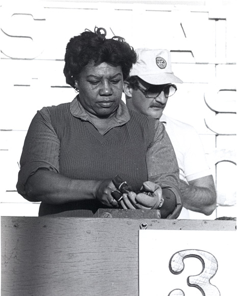 Photo of a woman shucking an oyster