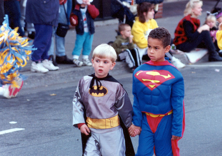 Photo of two children dressed as Batman and Superman