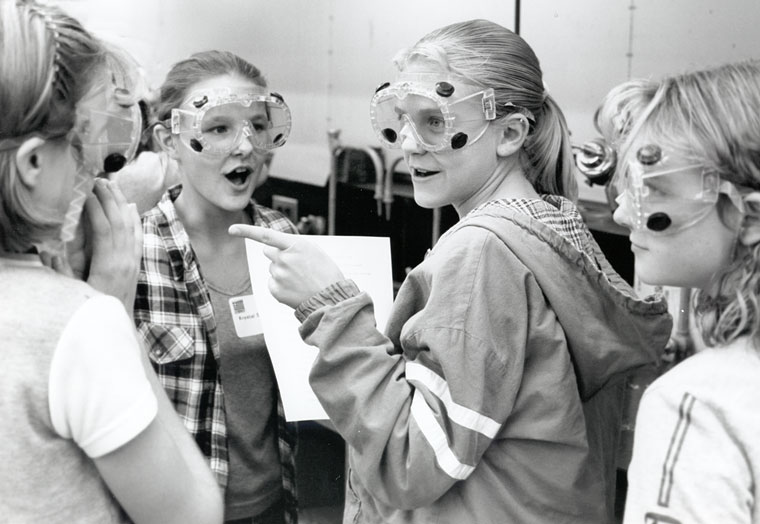 Photo of four girls in laboratory goggles