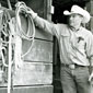 Photo of man in cowboy hat hanging up rope