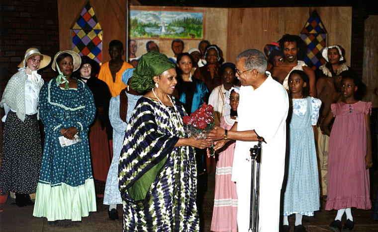 Photo of Dr. E.B. Palmer presenting roses to playwright Ann Hunt Smith