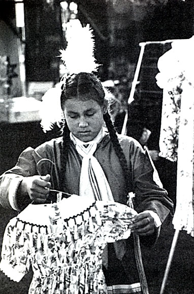Photo of person looking at tribal dress on a coat hanger