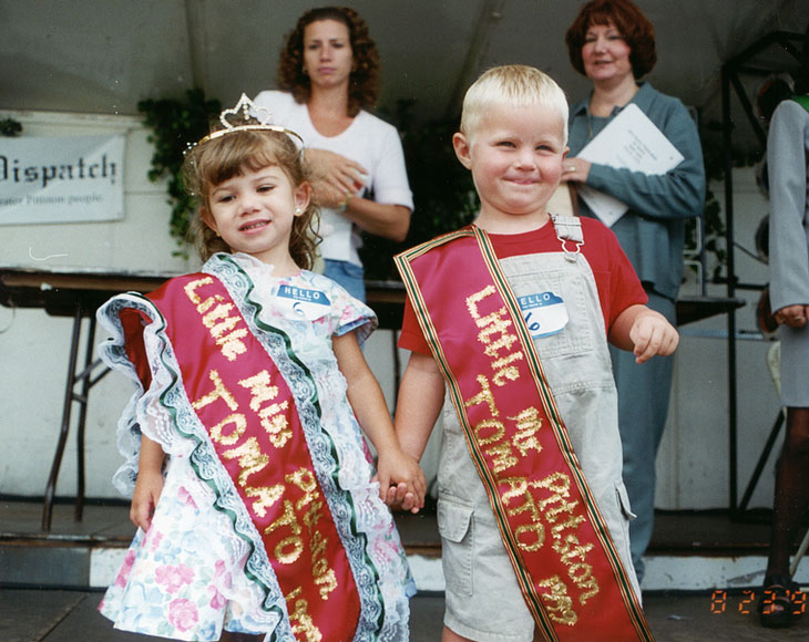 Photo of boy and a girl on stage wearing award sashes