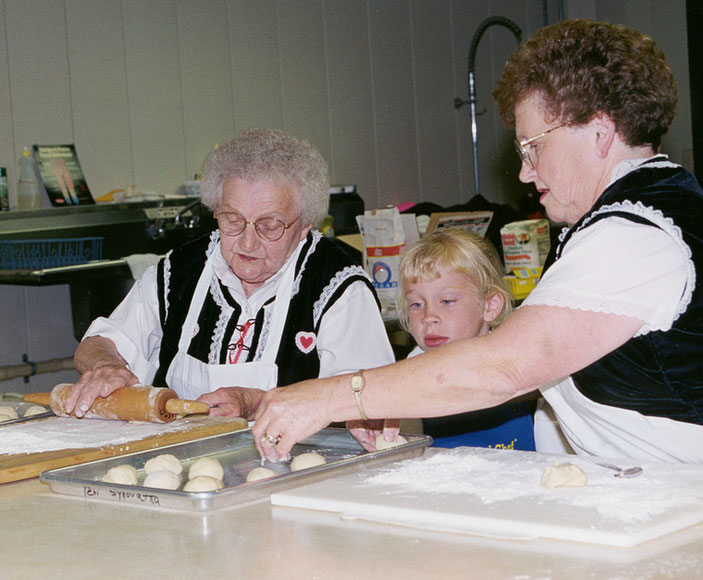 Photo of two women and a girl making kolaches