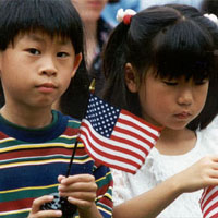 Photo of two children with small American flags