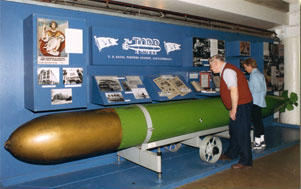 Photo of two visitors at exhibit on the Torpedo Factory's history