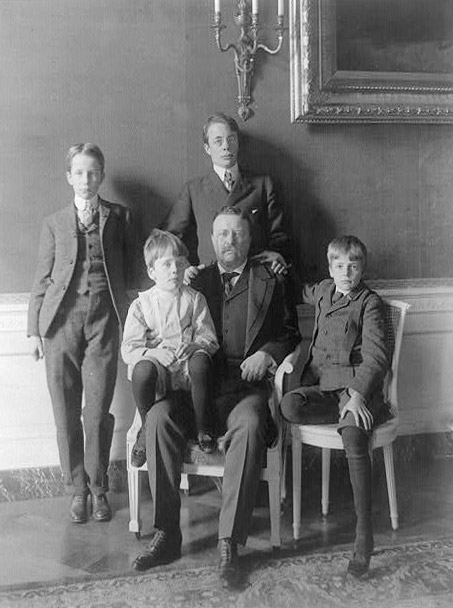 Theodore Roosevelt, full-length portrait, with his four sons posed around him