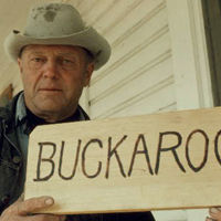 Les Stewart with Sign Made for Exhibit