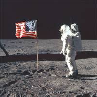 Neil Armstrong on the moon poses next to the Unites States flag, July 20, 1969