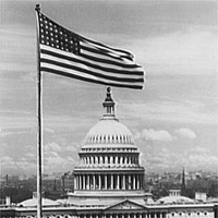 U.S. Capitol exteriors. Flag and east front of U.S. Capitol.