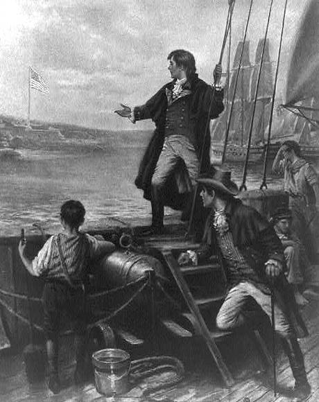 Francis Scott Key standing on boat, with right arm stretched out toward the United States flag flying over Fort McHenry, Baltimore, Maryland.