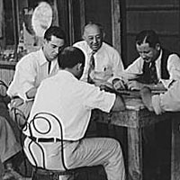 Playing dominoes or cards in front of drug store in center of town, in Mississippi Delta, Mississippi