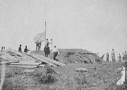 Hoisting the flag at Guantanamo, June 12, 1898.