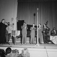 Portrait of Jack Teagarden, Dick Carey, Louis Armstrong, Bobby Hackett, Peanuts Hucko, Bob Haggart, and Sid Catlett, Town Hall, New York, 1947.