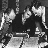 September 1944, Librarian of Congress Archibald MacLeish, center, joined Reference Department director David C. Mearns and Verner W. Clapp of the Acquisitions Department.