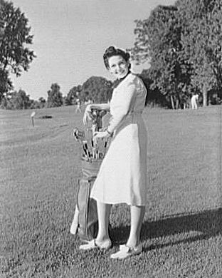 Woman with clubs on golf course