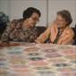 Ilene Flint, Vera Stanley, Ruth Spangler on side of quilt frame, 1978.