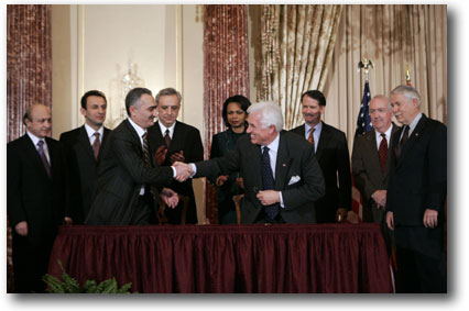 Ambassador John Danilovich, chief
executive officer of the Millennium Challenge Corporation, right center, shakes hands with
Armenian Minister of Finance and Economy Vardan Khachatryan