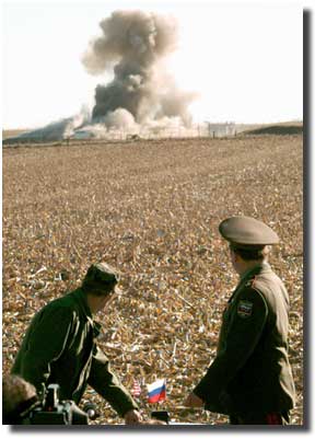 U.S. Secretary of Defense William Perry, left, and Russian Minister of Defense Pavel Grachev destroy an underground missile silo.
