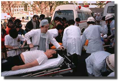 Rescue workers and medical personnel attend to subway passengers in Tokyo