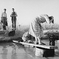 Oklahoma migratory workers washing in a desert hot spring