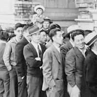 Photo of men registering for relocation in San Francisco, 1942
