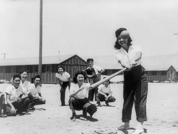 Photo of interned women playing softball, 1942