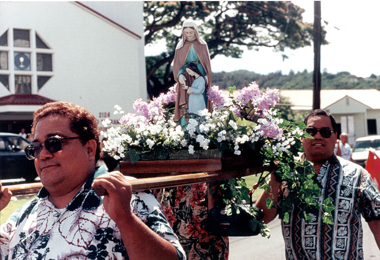 Men carrying a statue of Virgin Mary