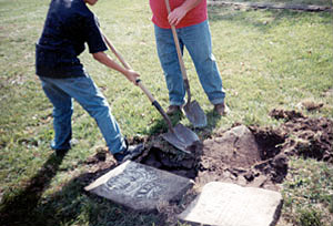 Photo of fifth-graders resetting a tombstone