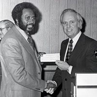 Photo of Governor Carroll presenting check to W.C. Young