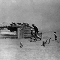 A farmer and his sons walk in a dust storm in Oklahoma in 1936.