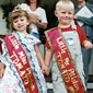 Photo of boy and a girl on stage wearing award sashes