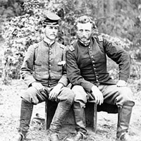 Confederate prisoner sits with Captain George Custer