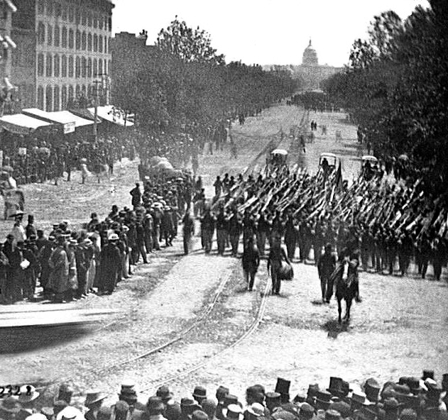 Washington, D.C. Infantry unit with fixed bayonets followed by ambulances passing on Pennsylvania Avenue near the Treasury, 1865