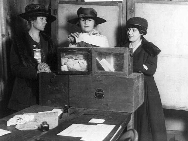 Three suffragists casting votes, 1917