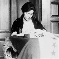 Alice Paul is shown sewing the thirty-sixth star on the suffrage ratification banner.