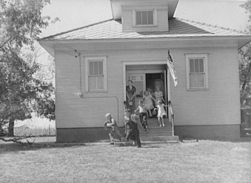 Kids run out of a schoolhouse in Grundy County, Iowa, 1939.